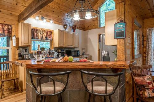 a kitchen with a counter with bar stools at Secluded Cabin with Hot-tub and Fire Pit in Cleveland, Georgia in Kinseytown