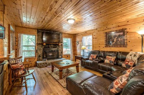 a living room with a leather couch and a fireplace at Secluded Cabin with Hot-tub and Fire Pit in Cleveland, Georgia in Kinseytown