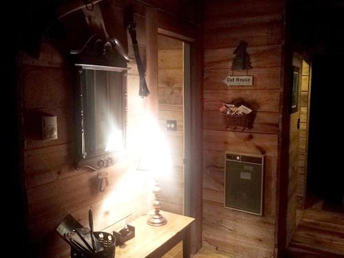 a room with a wooden wall with a table and a lamp at Cozy Vacation Rental with High-Speed Wi-Fi near Seven Springs, Pennsylvania in Champion