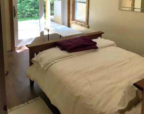 a white bed in a room with a window at Tranquil Vacation Rental Nestled in the Shenandoah Mountains of Howardsville, Virginia in Howardsville