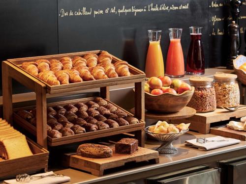 a display of pastries and other foods on a counter at Sofitel Paris Arc De Triomphe in Paris