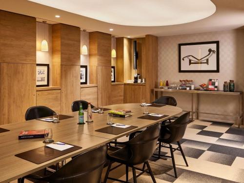 a conference room with a long table and chairs at Sofitel Paris Arc De Triomphe in Paris