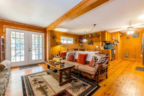 a living room with a couch and a table at Creekfront Cabin Amazing for Families in Helen, Georgia in Helen