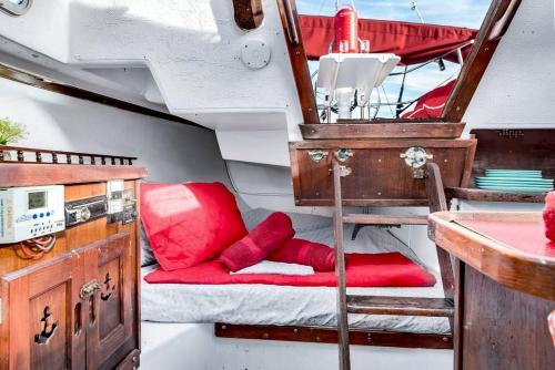 a small boat with a red seat and a table at Picturesque Equipped Boat Rental Incredible for a Relaxing Getaway in Florida in Moultrie Junction