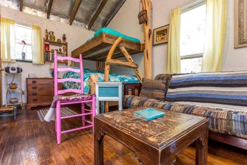 a living room with two bunk beds and a table at Rustic Cabin Rental Perfect for Families in Texas Hill County in Marble Falls