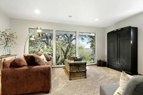 a living room with a couch and a large window at Inspiring Cottage Rental for a Vacation in California Wine Country in Lockeford