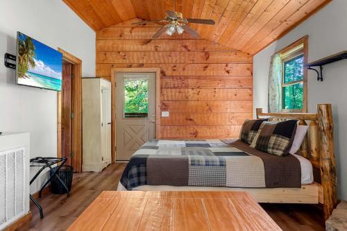 a bedroom with a bed and a ceiling fan at Charming Cabin with Spa and Mountain Views in Sevierville, Tennessee in Pinnacle