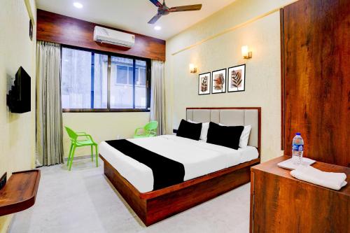 a bedroom with a bed and a desk and a window at Super Collection O Kalamboli New Panvel Formerly Golden Paradise in Kalamboli