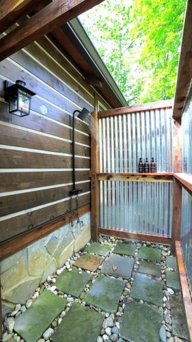 a patio with a wooden fence and a stone walkway at Relaxing Getaways to Chattanooga, Tennessee, in this Colorful Pet-Friendly Cabin in Whitwell
