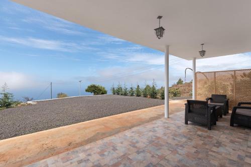 a patio with two chairs on top of a roof at Casa Tajinaste in Tijarafe