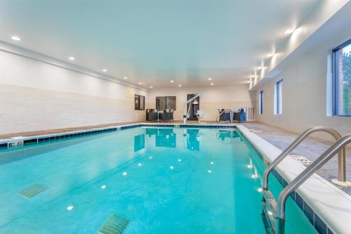 a swimming pool with blue water in a building at Hampton Inn Akron-South in Akron