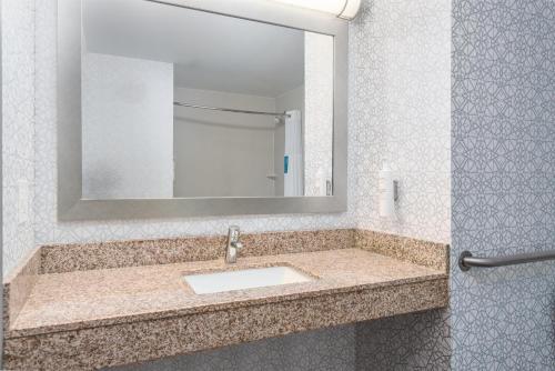 a bathroom with a sink and a mirror at Hampton Inn Akron-South in Akron