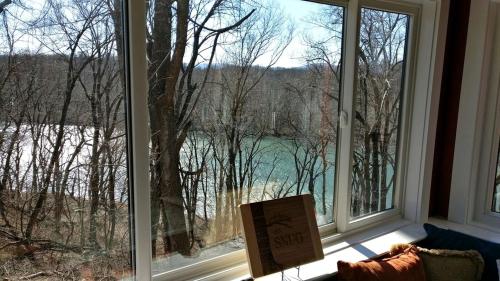a sign in front of a window with a view of a lake at Exquisite Sunny Cabin Rental with a Hot Tub in Front Royal, Virginia in Warren Park