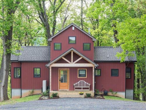a red house with a gambrel roof at Exquisite Sunny Cabin Rental with a Hot Tub in Front Royal, Virginia in Warren Park