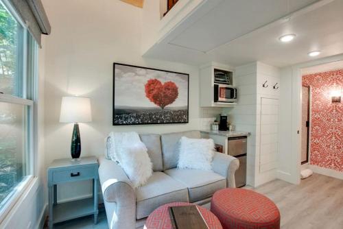 a living room with a couch and a table at Picturesque Tiny Cabin Surrounded by Nature in Alabama in Grant