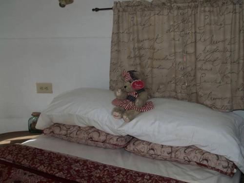 - deux ours en peluche assis au-dessus des oreillers sur un lit dans l'établissement Unique Glamping Rental with Amazing Hiking Trails near Gainesville, Florida, à Fort McCoy