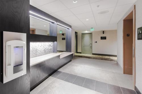 a bathroom with a urinal on the wall at Hampton Inn & Suites Raleigh-Durham Airport-Brier Creek in Raleigh