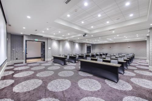 a conference room with rows of chairs and a screen at Hampton Inn & Suites Raleigh-Durham Airport-Brier Creek in Raleigh