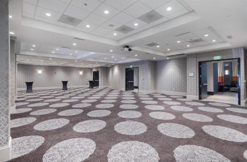 a large room with a large rug on the floor at Hampton Inn & Suites Raleigh-Durham Airport-Brier Creek in Raleigh