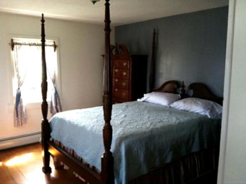 a bedroom with a four poster bed and a window at Historic Cabin Rental with Mountain Views in Potter County, Pennsylvania in Short Run