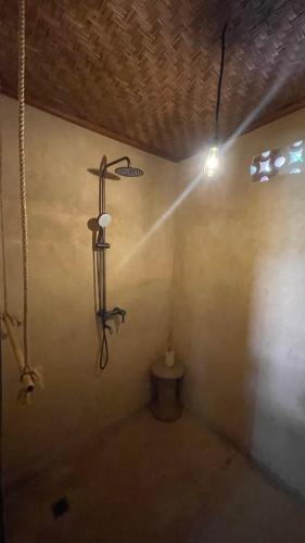 a room with a cross on the wall with a light at The House of The Rising Tide in Mantaak