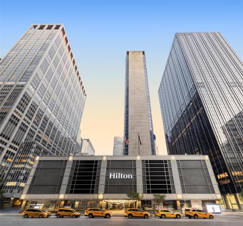 a group of taxis parked in front of a building at New York Hilton Midtown in New York