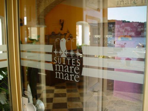 a glass door of a store with a sign on it at Mare Mare Suites in Mali Lošinj