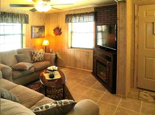 a living room with a couch and a television at Picturesque Cabin Incredible for a Holiday Escape in Inverness, Florida in Inverness