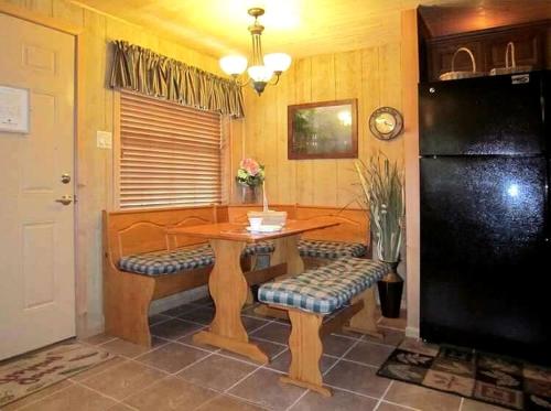 a dining room with a wooden table and benches at Picturesque Cabin Incredible for a Holiday Escape in Inverness, Florida in Inverness