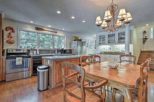 a kitchen with a wooden table and a dining room at Delightful Waterfront Cabin Rental Overlooking Lake Martin, Elmore County, Alabama in Equality