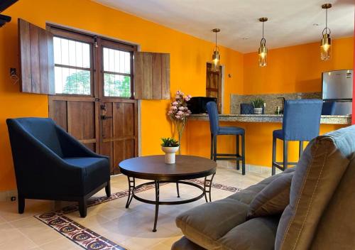 a living room with a couch and a table at Casa Michela512 ,Piscina y Mérida centro in Mérida