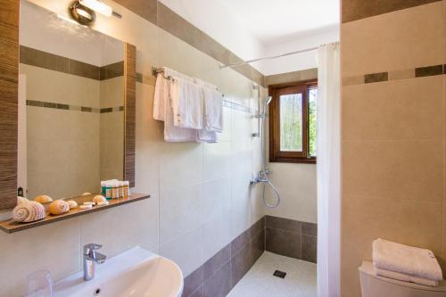 a bathroom with a sink and a toilet and a shower at Naftilos Skiathos in Skiathos