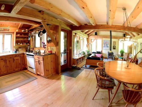 a kitchen and dining room with a table in a room at Cozy Lakefront Cabin Rental in the Woodlands of Empire, Michigan in Maple City