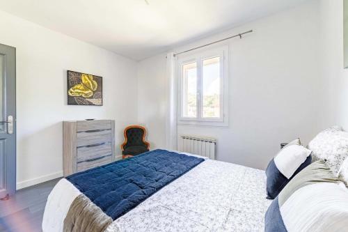 a bedroom with a large bed and a window at Apartment with pool and garden in Taradeau