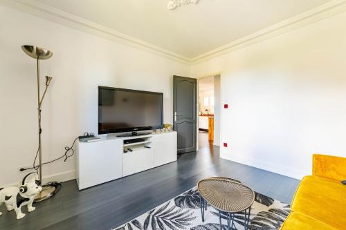 a living room with a large flat screen tv at Apartment with pool and garden in Taradeau