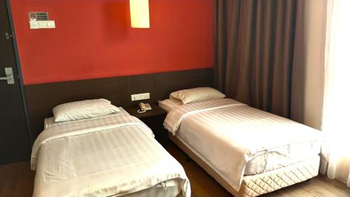 Кровать или кровати в номере GPI HOTEL Bentong