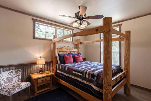 a bedroom with a wooden bunk bed with a ceiling fan at Two-Bedroom Cabin Rental with Fully Equipped Kitchen near Fredericksburg, Texas in Quinlan