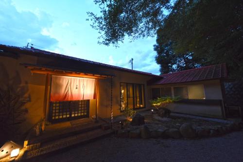 a house with a lit up window in front of it at 鈴音 by 4S STAY in Sanuki