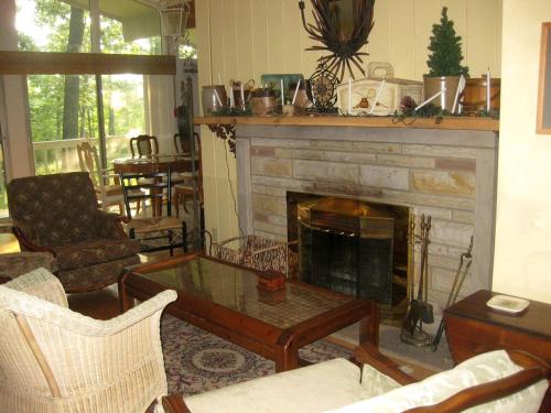 a living room with a fireplace and a coffee table at Peaceful Cabin Getaway Overlooking Tuscarawas River Valley in New Philadelphia, Ohio in New Philadelphia
