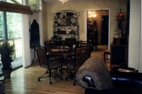 a living room with a table and chairs at Peaceful Cabin Getaway Overlooking Tuscarawas River Valley in New Philadelphia, Ohio in New Philadelphia