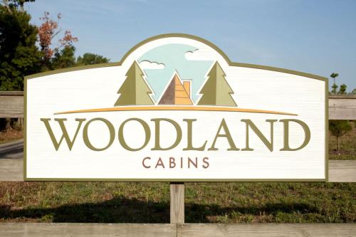 a sign for a woodland cattins at Rustic Cozy Cabin with Hot-tub in Carbondale, Illinois in Etherton