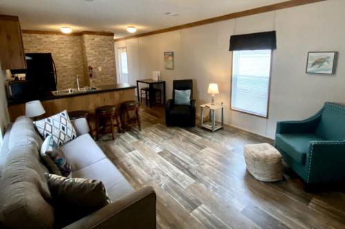 a living room with a couch and a kitchen at Off-Grid Cottage with Nice Sights in Dunnellon, Florida in Dunnellon