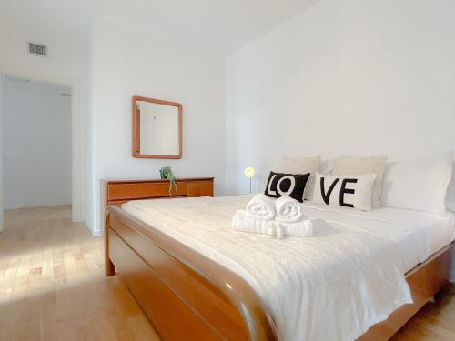 a bedroom with a large bed with towels on it at Vista Mare - Spiaggia a 50 mt - AC in Savona