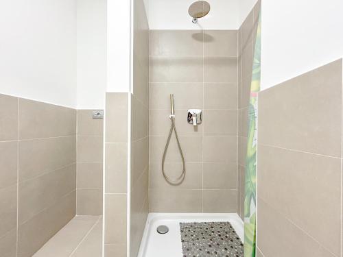 a bathroom with a shower with a shower curtain at Vista Mare - Spiaggia a 50 mt - AC in Savona