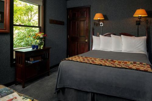 a hotel room with a bed and a window at Riverfront Cabin Rental with a Private Beach on Youghiogheny River near Pittsburgh, Pennsylvania in Confluence