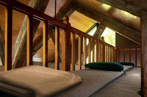 a bed in a room with a wooden ceiling at Riverfront Cabin Rental with a Private Beach on Youghiogheny River near Pittsburgh, Pennsylvania in Confluence