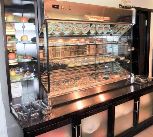 a bakery with a display case filled with donuts at Hotel Aleluia in Fátima
