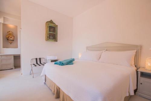 a white bedroom with a large white bed in a room at The Old Markets in Symi