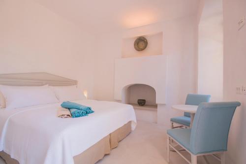 a bedroom with a bed with a person laying on it at The Old Markets in Symi