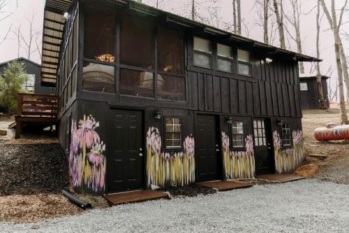 a house with graffiti on the side of it at Experience the Magic of Our Original Family Cabin in Tracy City, TN in Tracy City